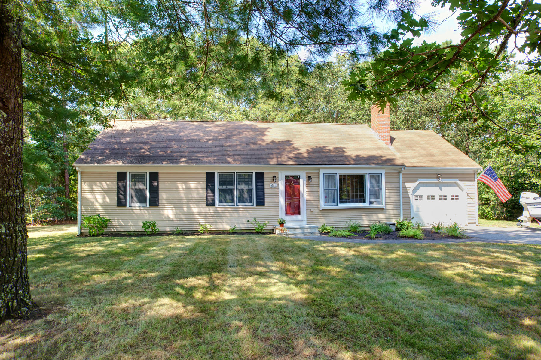 291 Skunknet Road Centerville, MA 02632 - Photo 3 of 39 a front view of a house with a garden