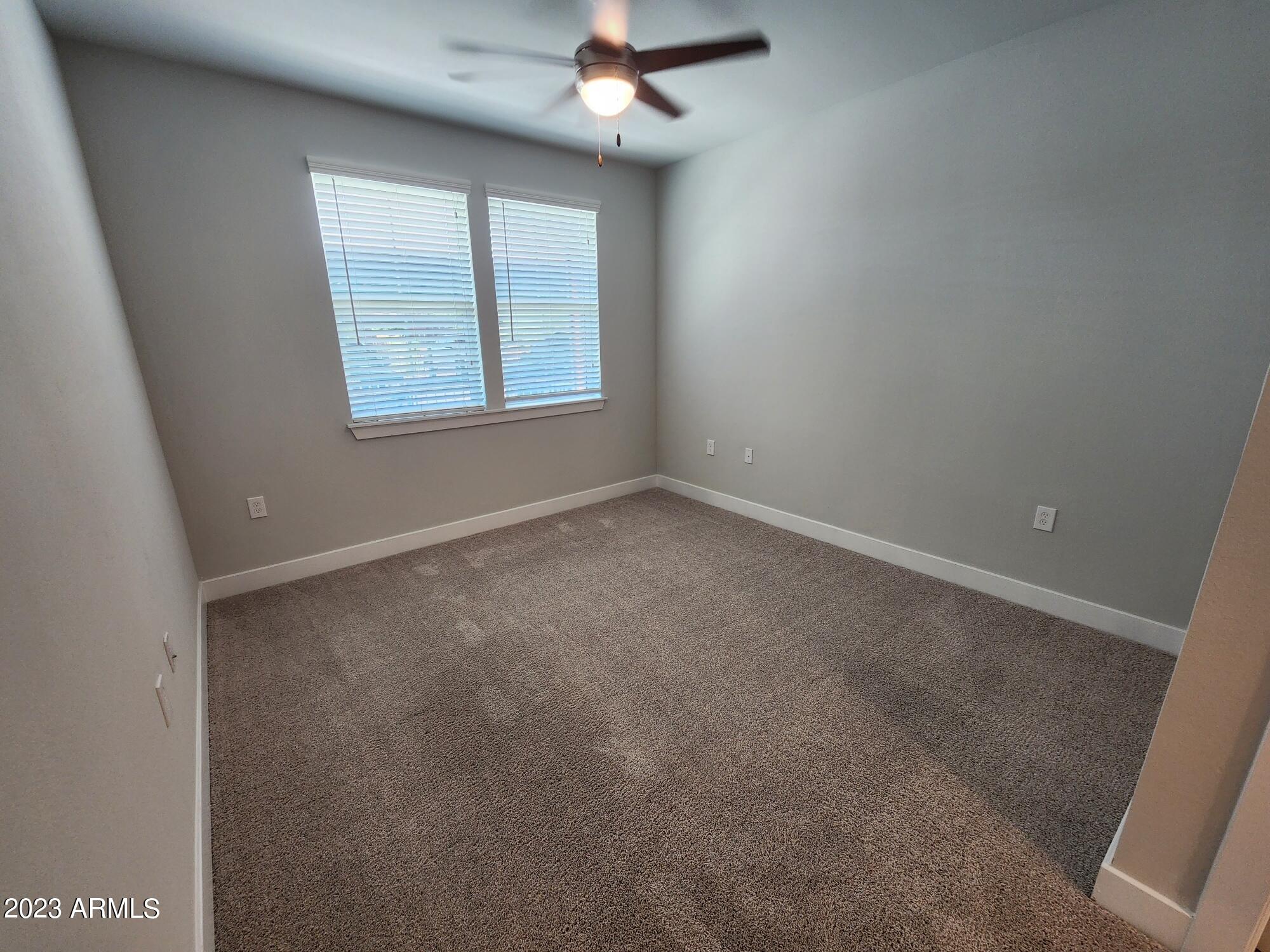 1375 North 145th Avenue, Unit B2 Goodyear, AZ 85395 - Photo 5 of 28 an empty room with a window