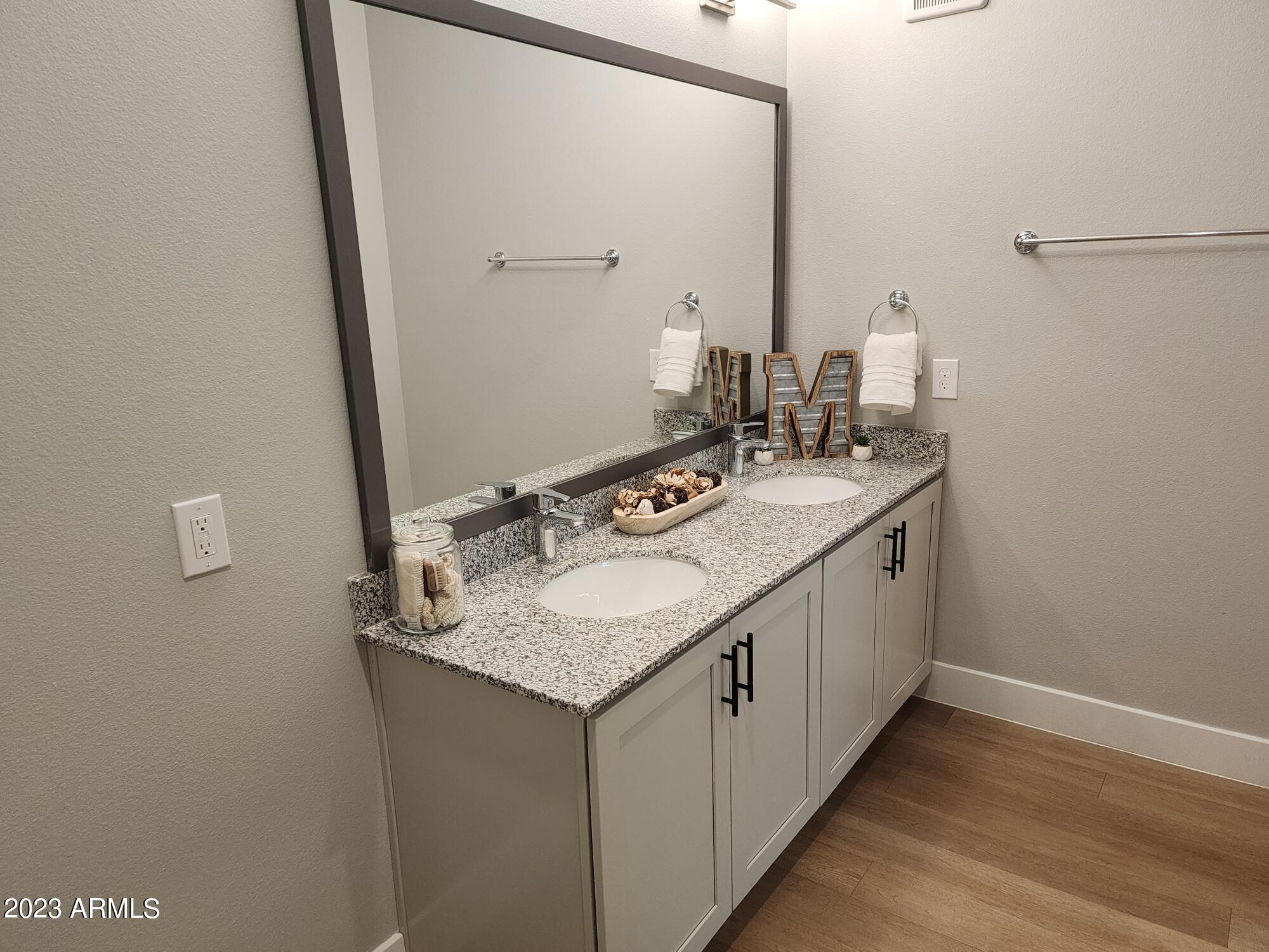 1375 North 145th Avenue, Unit B2 Goodyear, AZ 85395 - Photo 7 of 28 a bathroom with a sink and a mirror