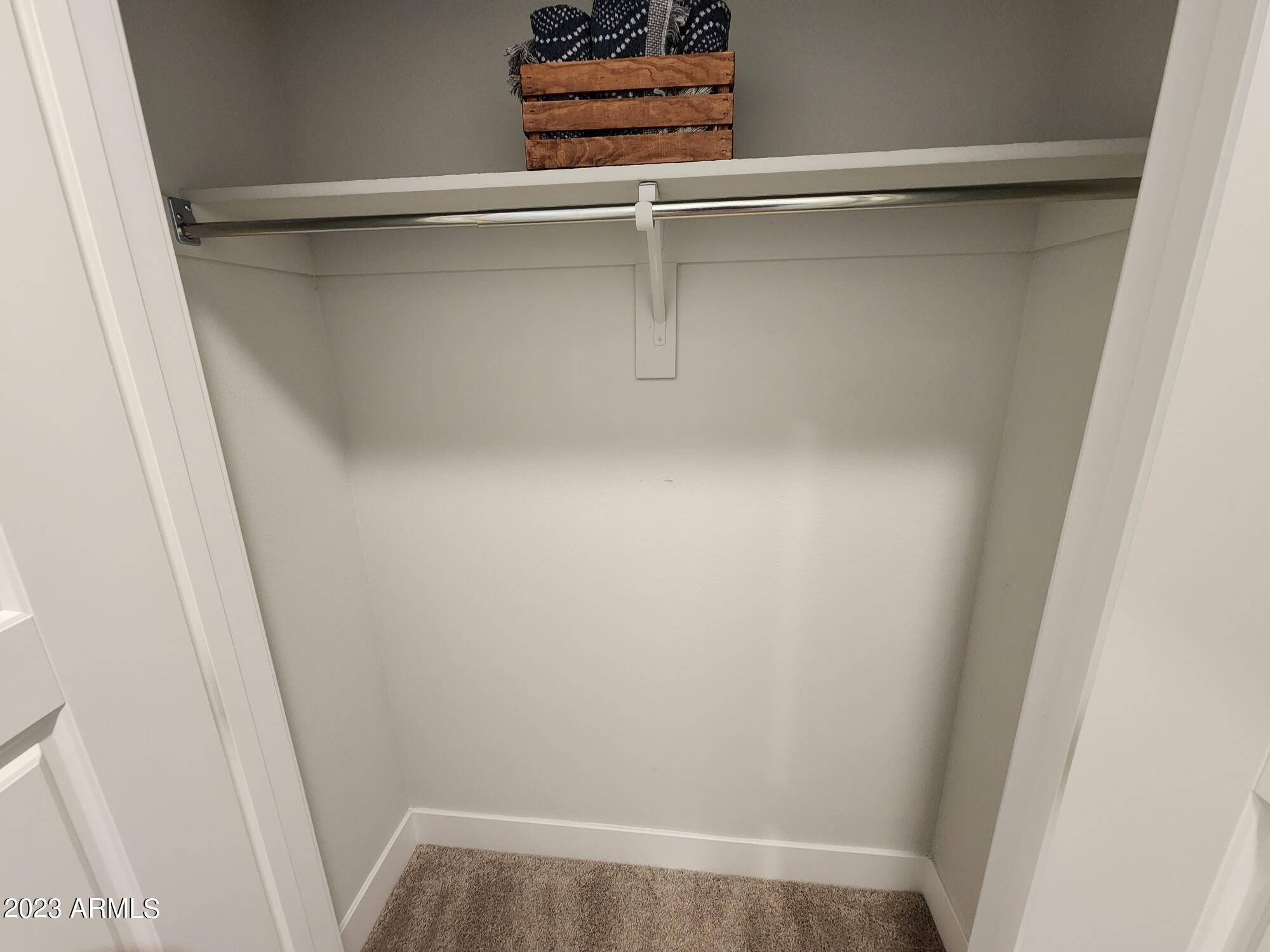 1375 North 145th Avenue, Unit B2 Goodyear, AZ 85395 - Photo 9 of 28 a view of walk in closet with empty racks