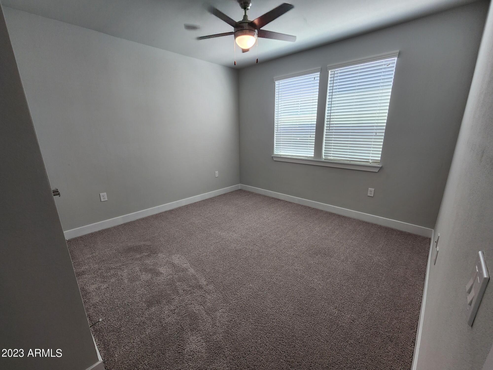 1375 North 145th Avenue, Unit B2 Goodyear, AZ 85395 - Photo 10 of 28 an empty room with windows and fan