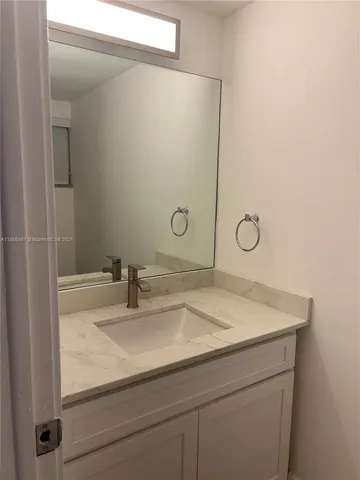 a bathroom with a sink and vanity