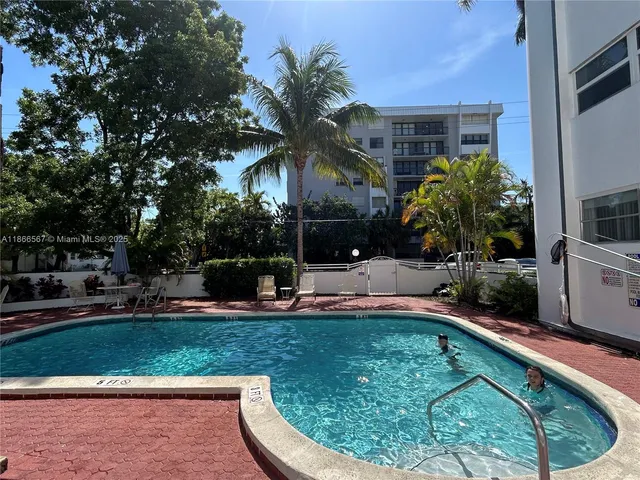 a swimming pool with outdoor seating and yard