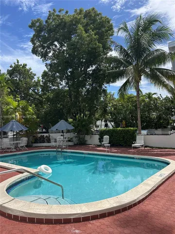 a view of a swimming pool with a yard