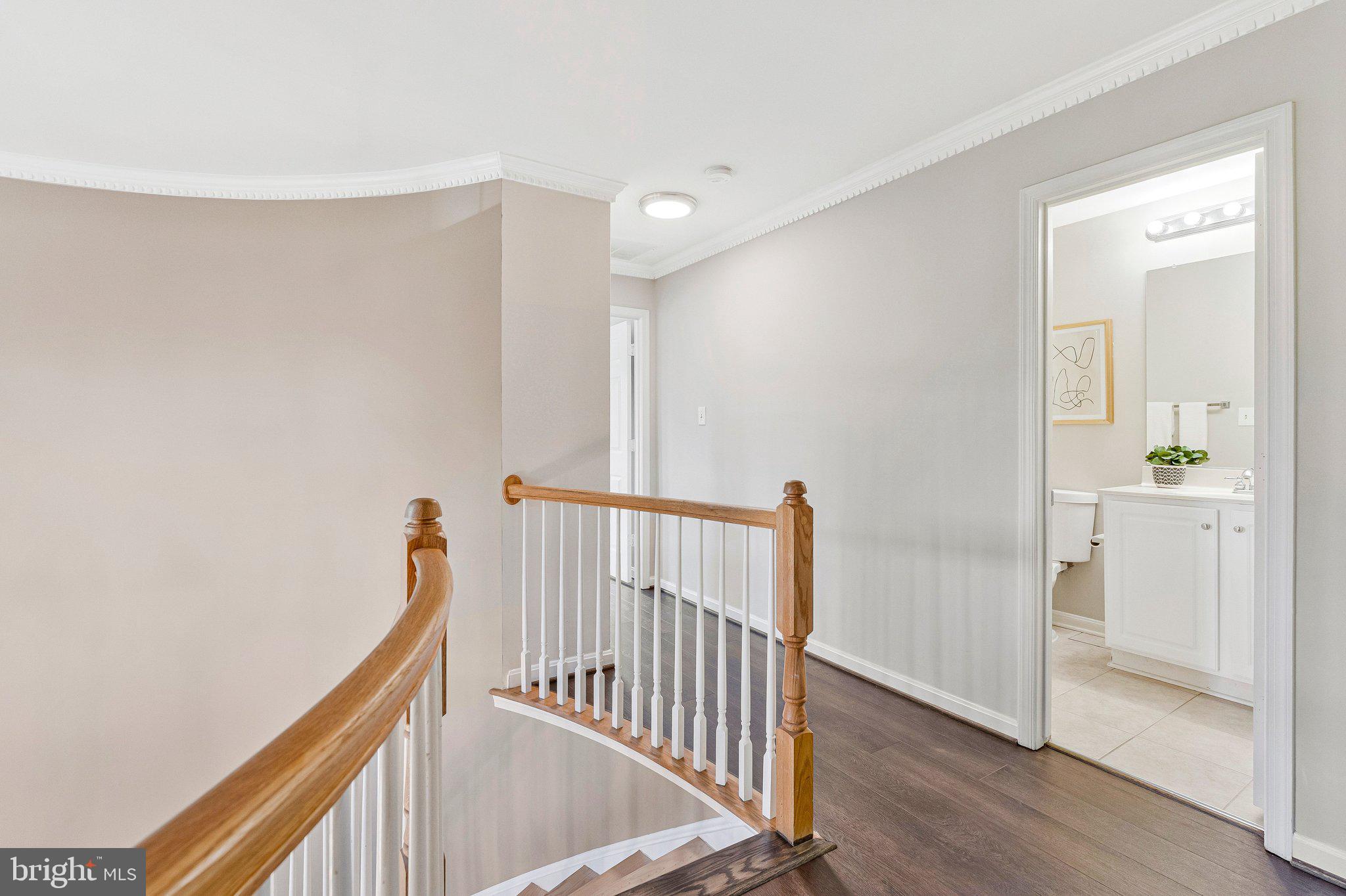 2000 Gallows Tree Lane Vienna, VA 22182 - Photo 23 of 58 a view of a hallway with wooden floor and staircase