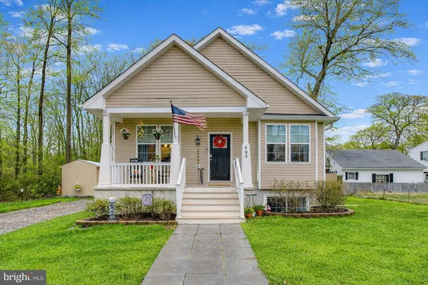a view of a house with a yard and sitting area