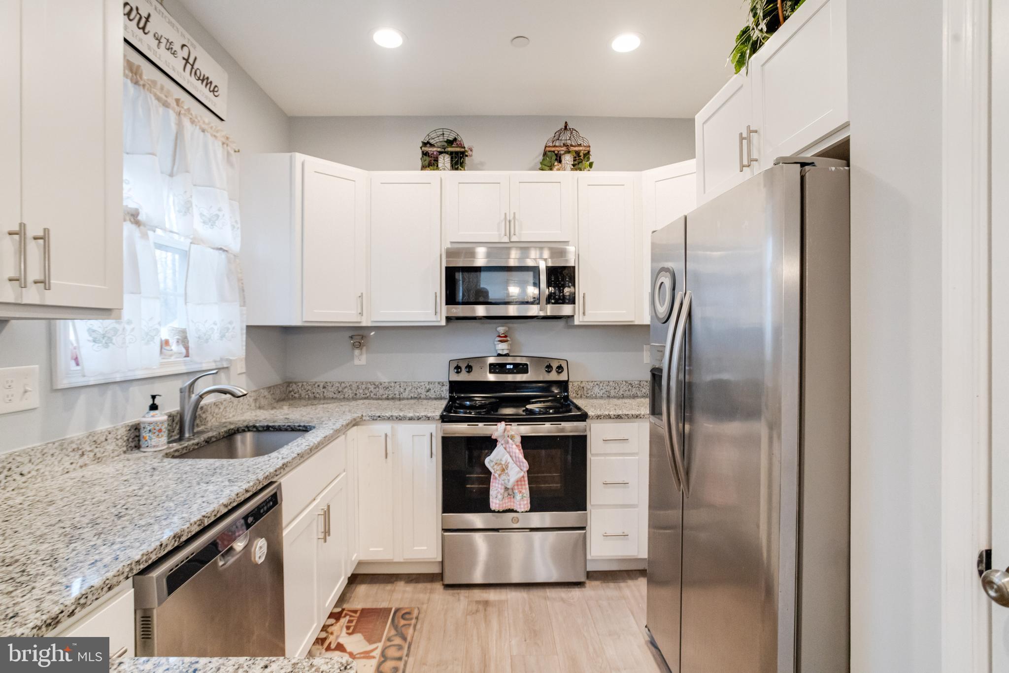 708 Hyde Park Road Essex, MD 21221 - Photo 20 of 65 a kitchen with stainless steel appliances granite countertop a stove a refrigerator and a sink
