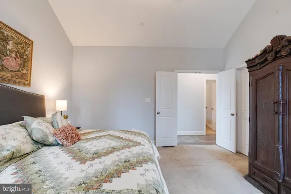 a bedroom with a bed and a couch