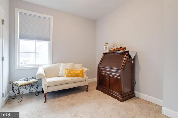a playing room with furniture and a wooden floor