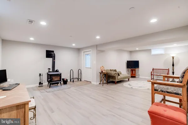 a bed sitting in a bedroom next to a window and wooden floor