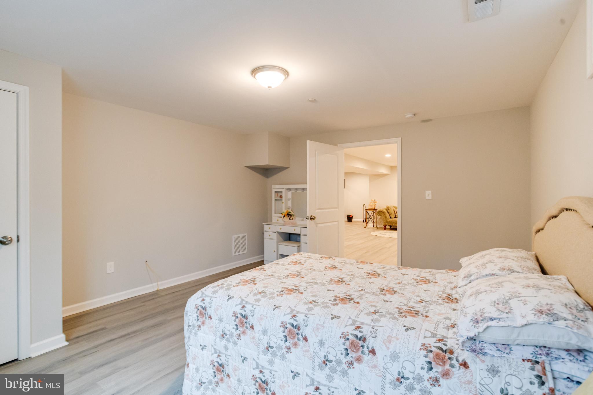 708 Hyde Park Road Essex, MD 21221 - Photo 58 of 65 a bedroom with a bed and wooden floor