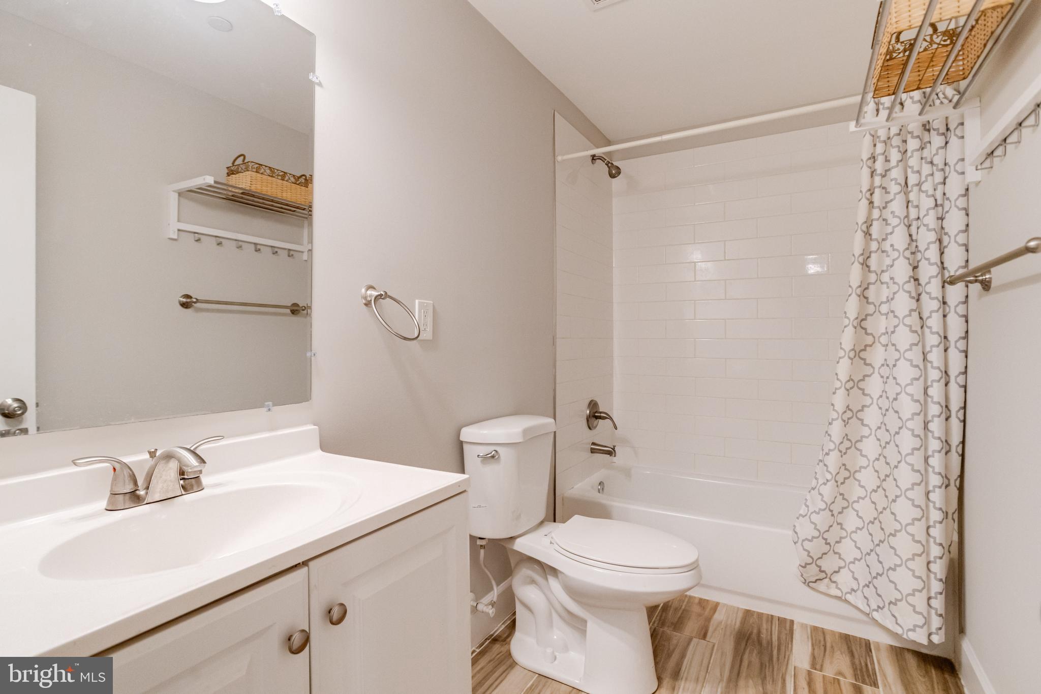 708 Hyde Park Road Essex, MD 21221 - Photo 59 of 65 a bathroom with a sink toilet and shower