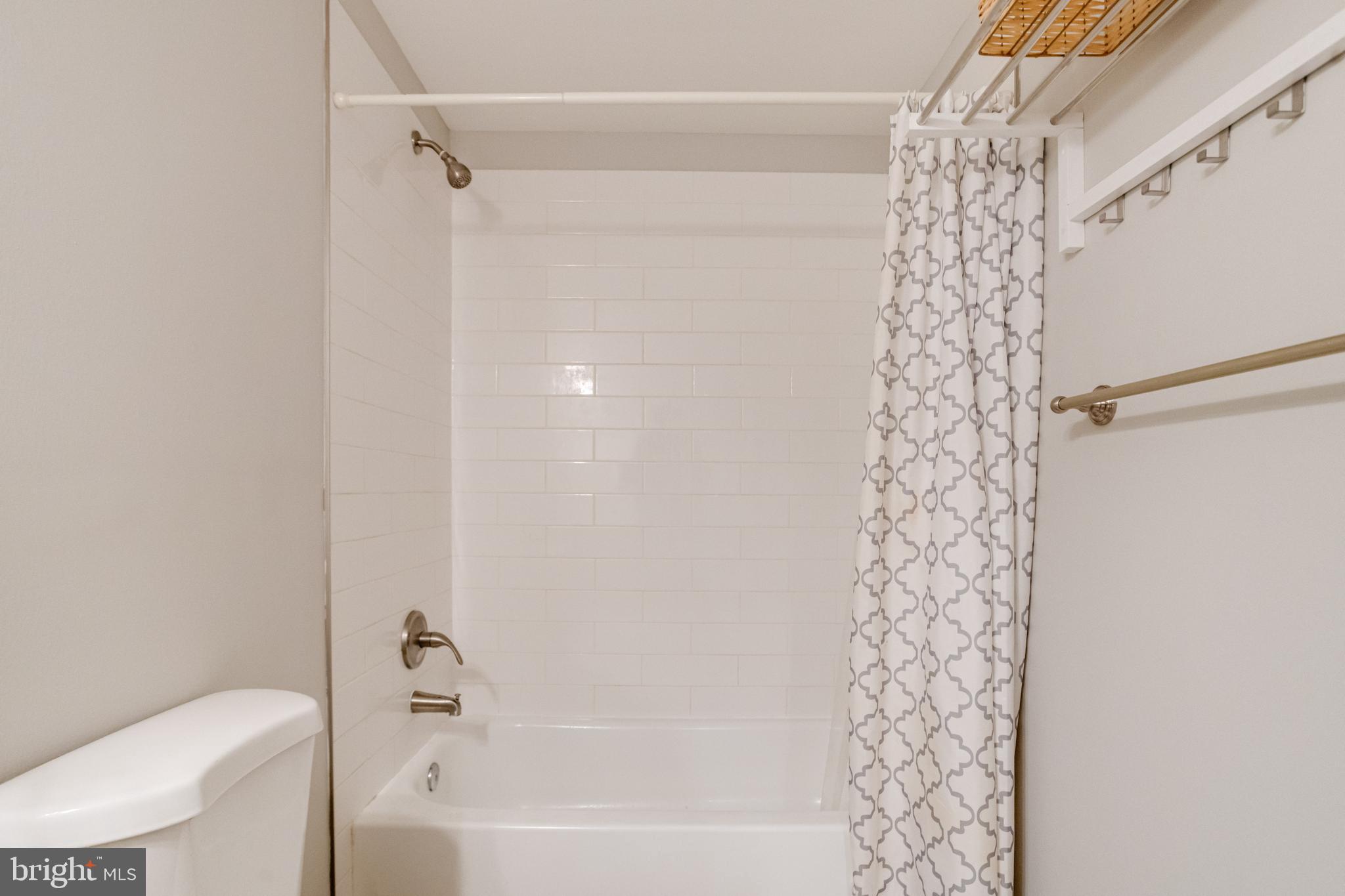 708 Hyde Park Road Essex, MD 21221 - Photo 60 of 65 a bathroom with a shower curtain and a toilet
