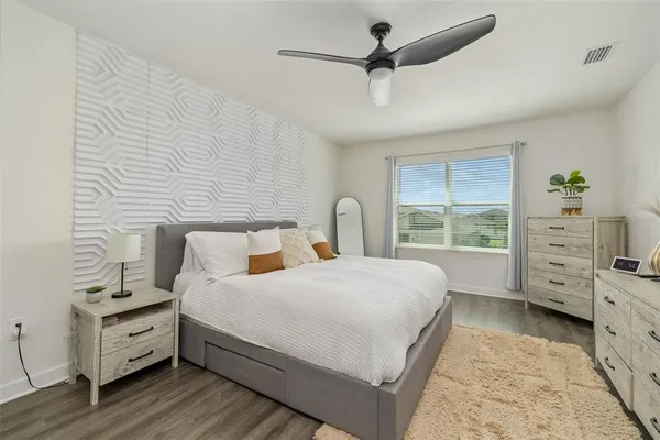 a bedroom with a bed and a chandelier
