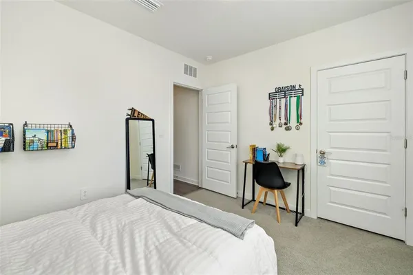 a sitting area with glass top table and chairs