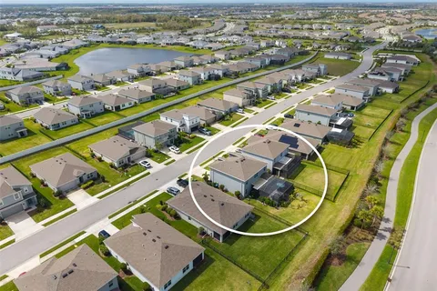 an aerial view of residential houses with outdoor space and swimming pool