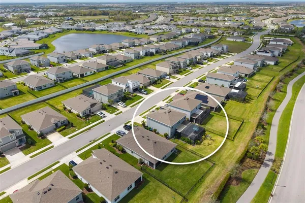 an aerial view of residential houses with outdoor space and swimming pool