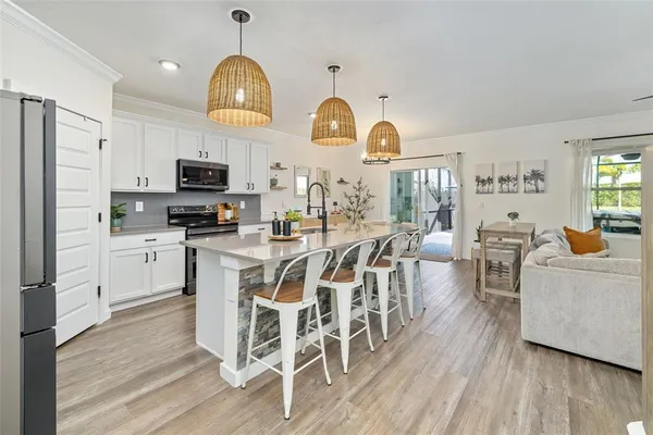 a kitchen with a sink stainless steel appliances and cabinets