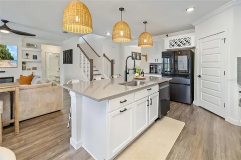 a kitchen with stainless steel appliances a refrigerator and a sink