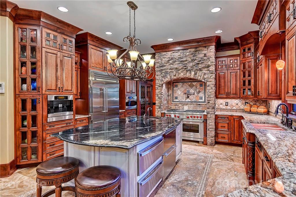 21123 Torrence Chapel Road Cornelius, NC 28031 - Photo 17 of 35 a kitchen with stainless steel appliances granite countertop a stove a sink and a microwave