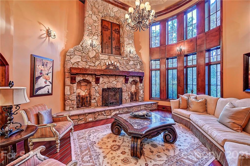 21123 Torrence Chapel Road Cornelius, NC 28031 - Photo 20 of 35 a living room with furniture a chandelier and a fireplace