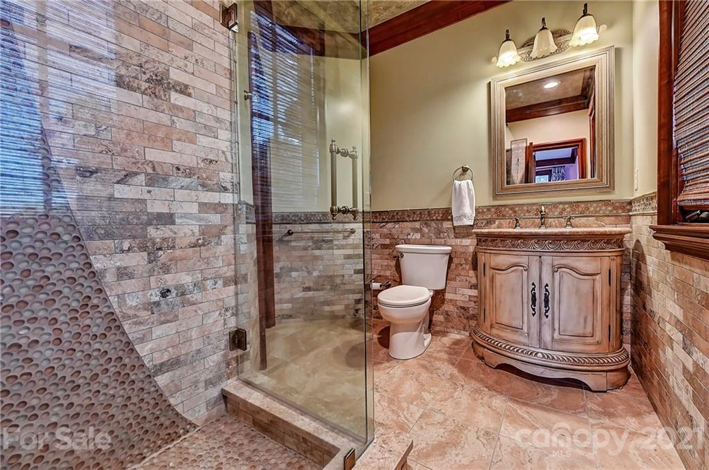 21123 Torrence Chapel Road Cornelius, NC 28031 - Photo 30 of 35 a spacious bathroom with a granite countertop toilet sink and mirror