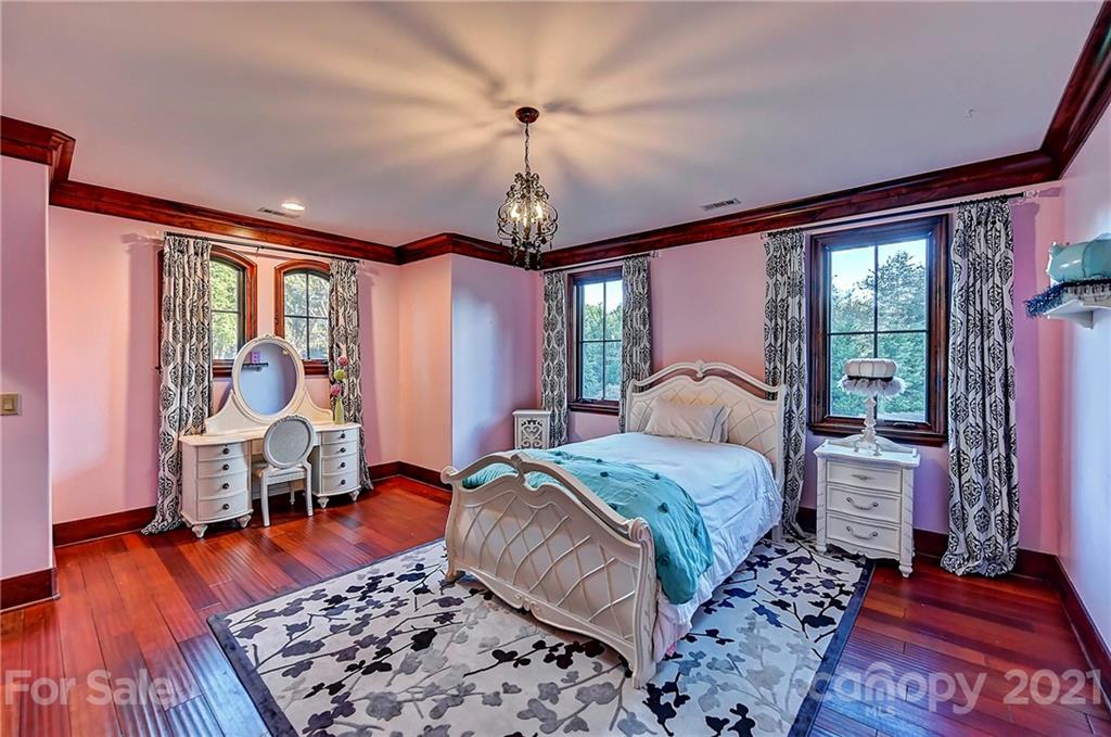 21123 Torrence Chapel Road Cornelius, NC 28031 - Photo 31 of 35 a bed room with a bed and a chair