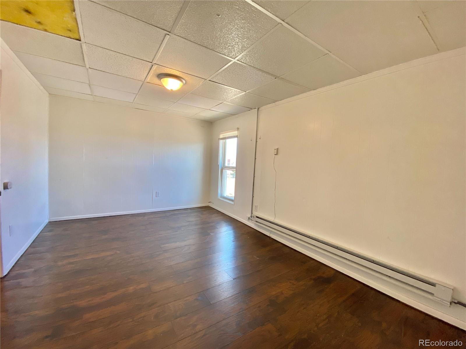 2422 West Vermijo Avenue, Unit 3 Colorado Springs, CO 80904 - Photo 4 of 7 a view of a room with wooden floor