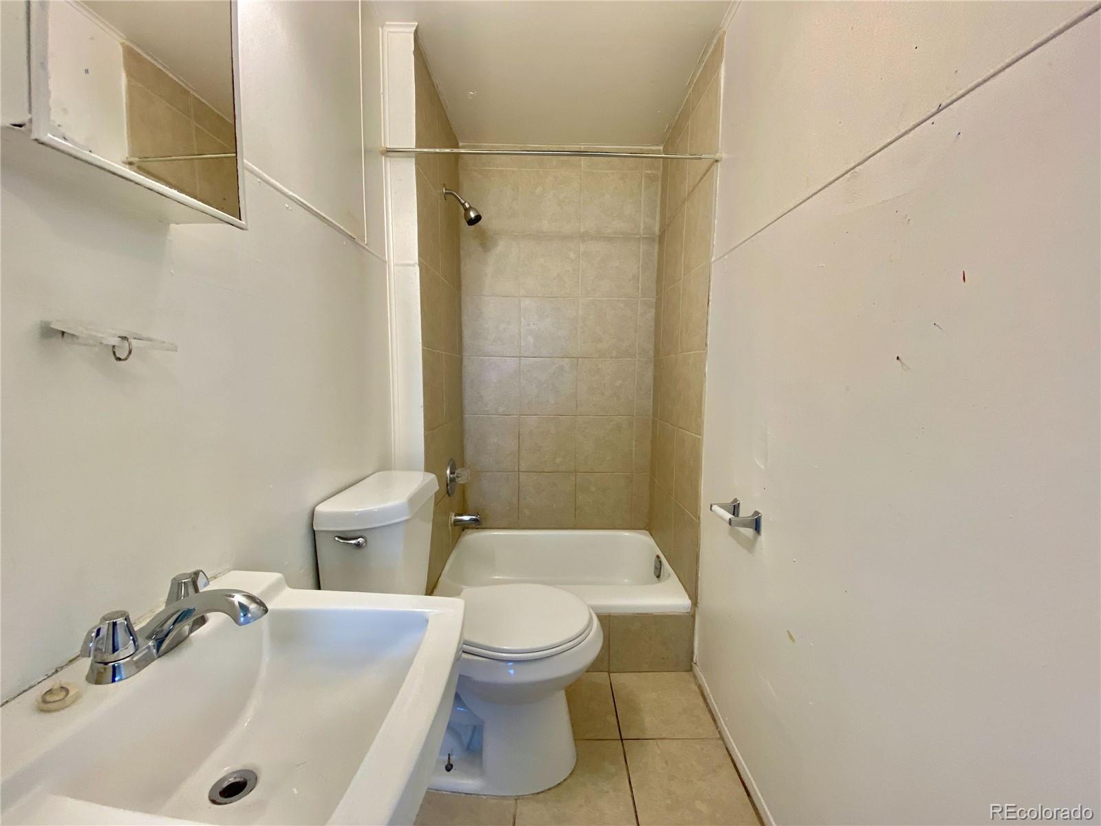 2422 West Vermijo Avenue, Unit 3 Colorado Springs, CO 80904 - Photo 7 of 7 a bathroom with a sink toilet and shower