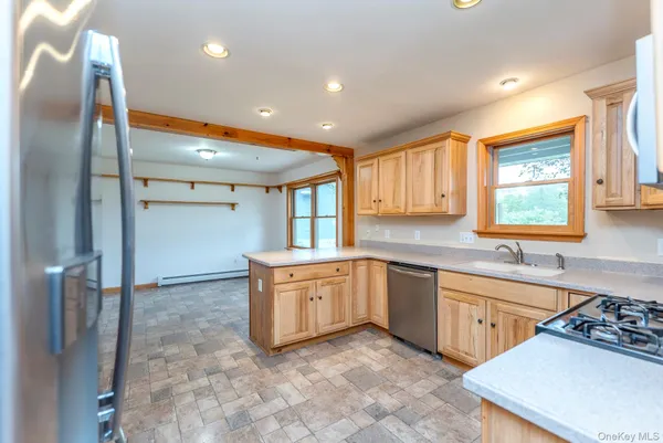 a large kitchen with stainless steel appliances granite countertop a sink and a stove