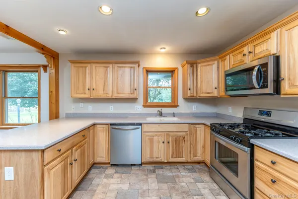 a kitchen with stainless steel appliances granite countertop a sink and stove top oven
