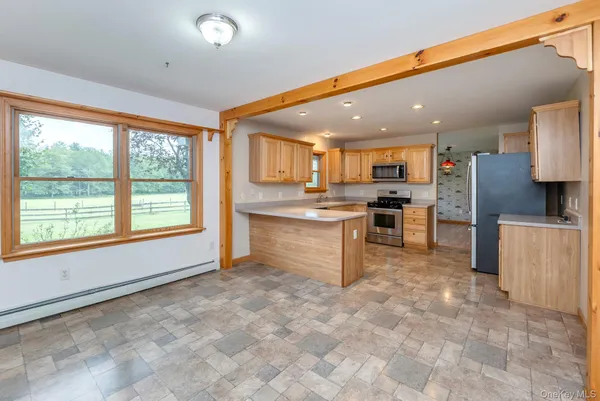 a kitchen with stainless steel appliances granite countertop a refrigerator and a stove top oven