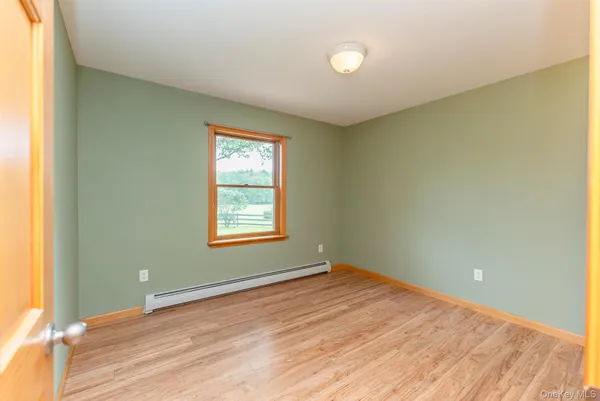 an empty room with wooden floor and closet