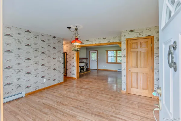 a view of a bedroom with wooden floor and windows