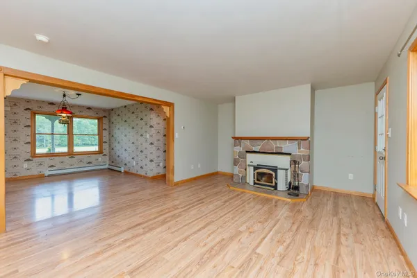 wooden floor fireplace and natural light in room