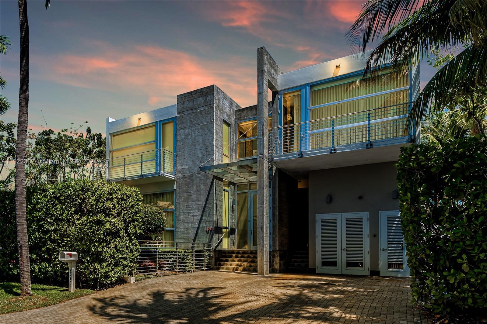 a view of a brick house with a large windows and a yard