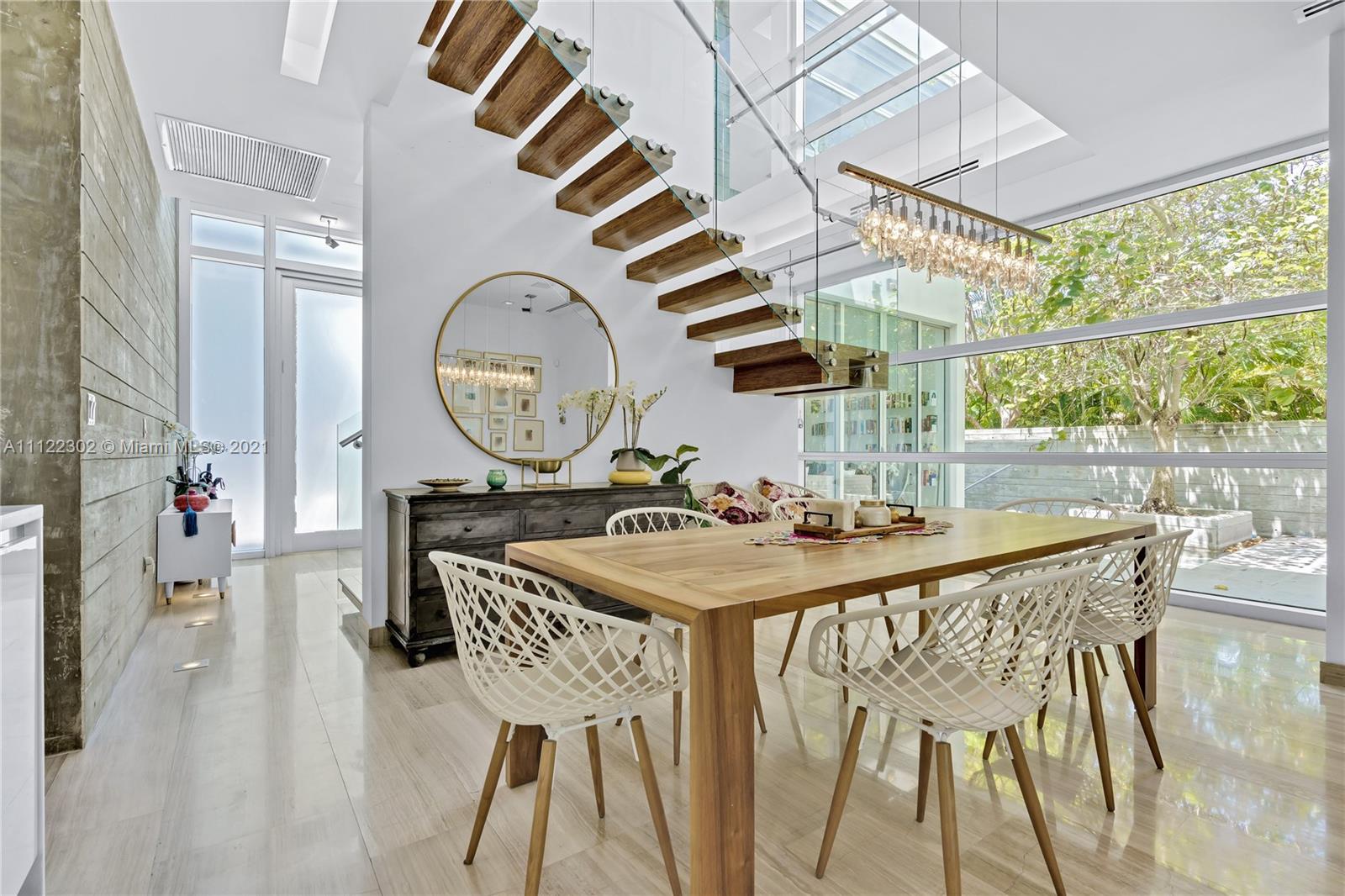 155 Hampton Lane Key Biscayne, FL 33149 - Photo 2 of 19 a view of a dining room with furniture and a large window