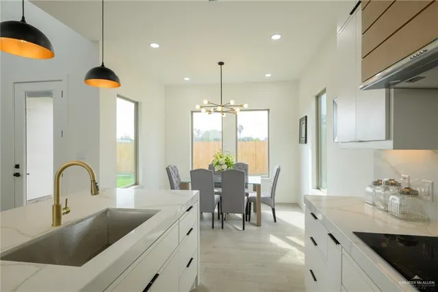 a kitchen with counter top space a sink cabinets and appliances