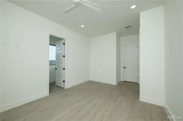 an empty room with wooden floor