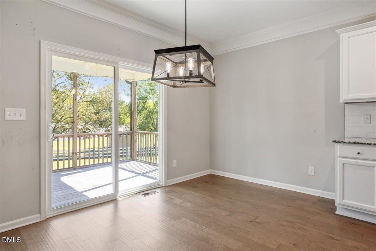 3361 Old Fairground Road Angier, NC 27501 - Photo 20 of 40 a view of empty room with wooden floor and fan