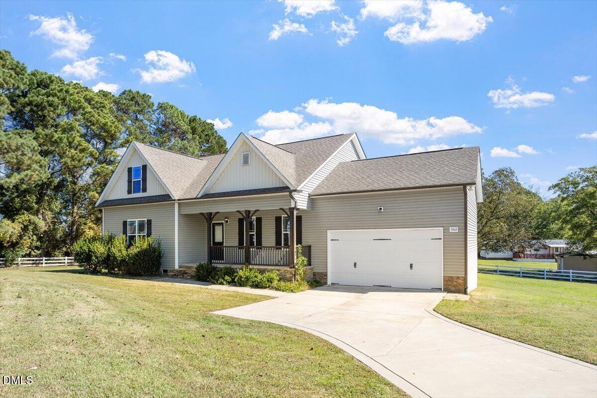 3361 Old Fairground Road Angier, NC 27501 - Photo 2 of 40 a front view of a house with a yard and garage