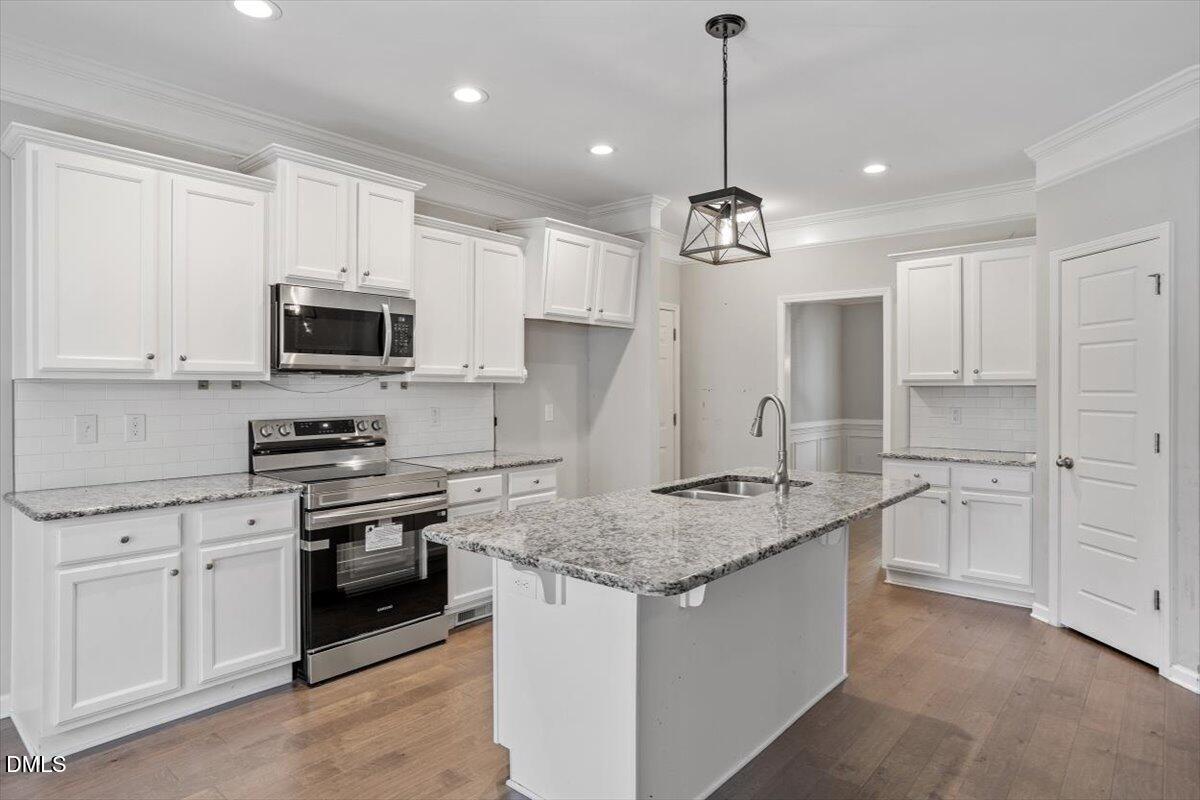 3361 Old Fairground Road Angier, NC 27501 - Photo 22 of 40 a kitchen with stainless steel appliances granite countertop a sink dishwasher a stove and a refrigerator