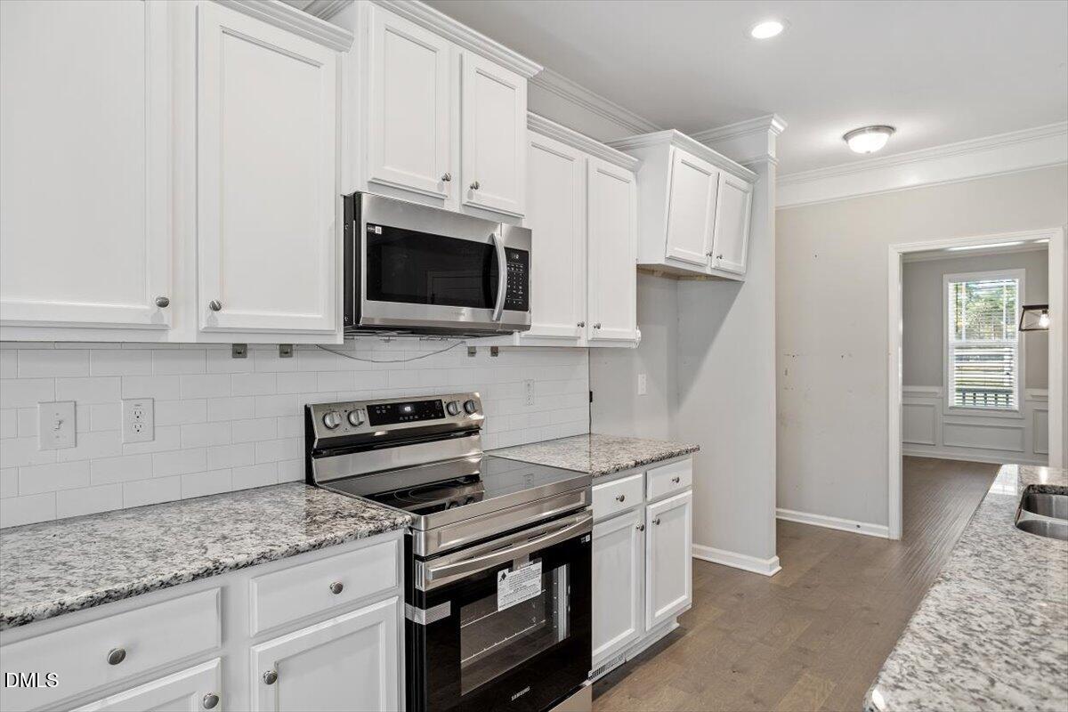 3361 Old Fairground Road Angier, NC 27501 - Photo 23 of 40 a kitchen with stainless steel appliances granite countertop a stove a sink and a microwave