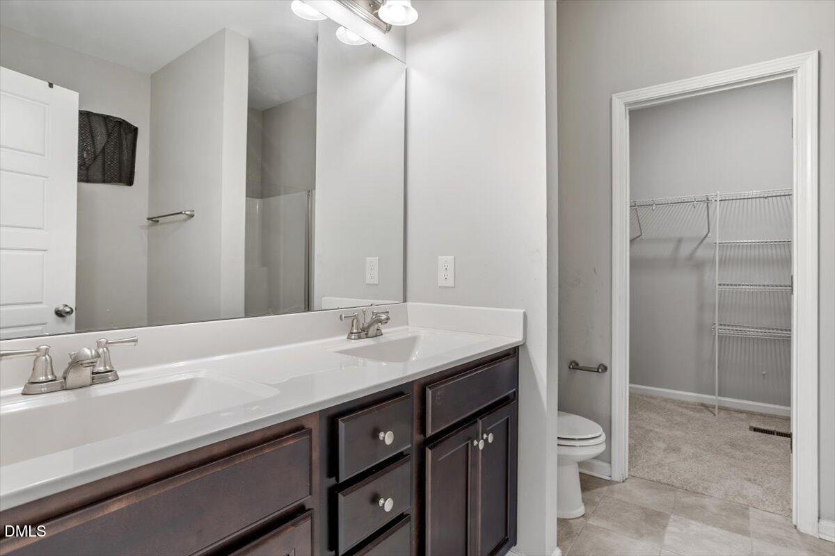 3361 Old Fairground Road Angier, NC 27501 - Photo 33 of 40 a bathroom with a granite countertop sink a toilet and shower