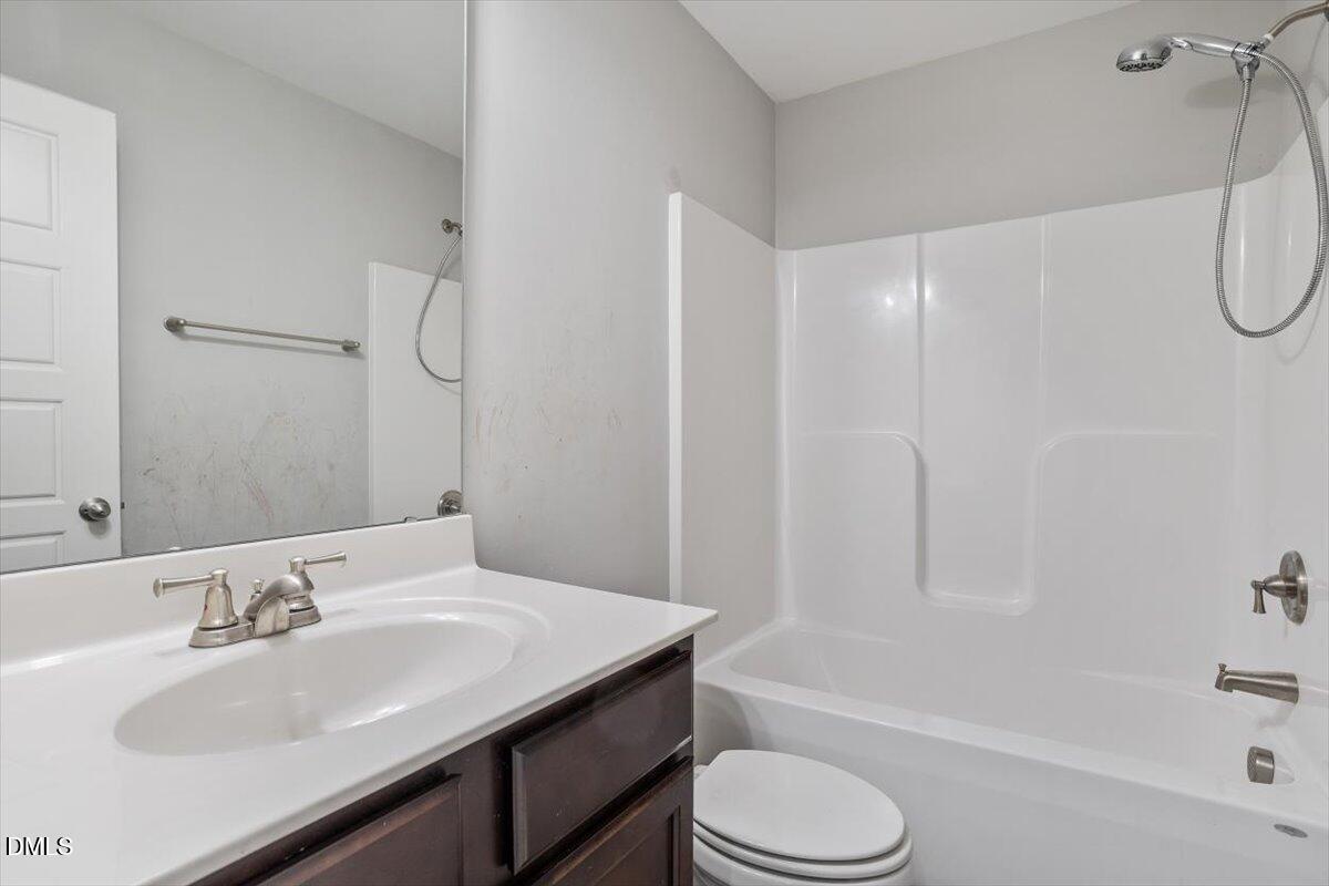 3361 Old Fairground Road Angier, NC 27501 - Photo 36 of 40 a bathroom with a granite countertop sink toilet and shower