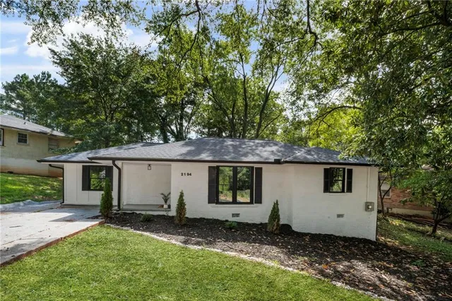 a front view of house with a garden