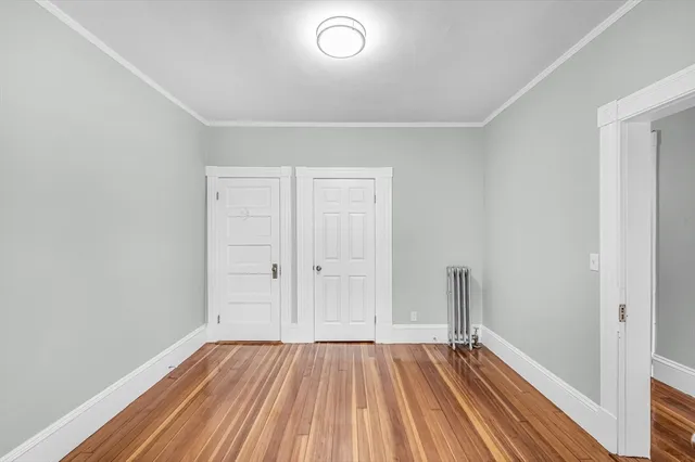 a view of room with window and wooden floor