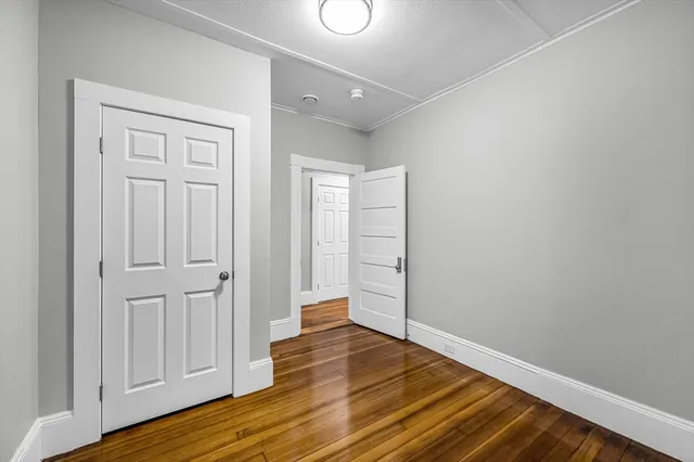 a view of a room with wooden floor
