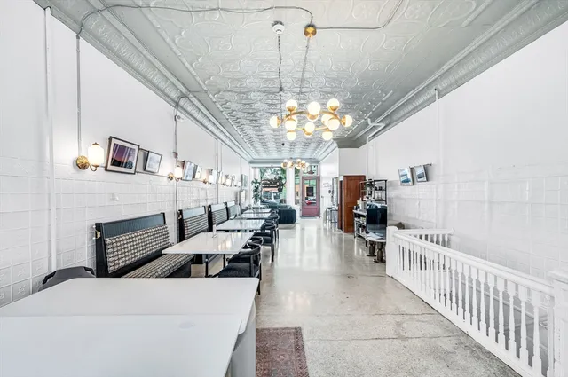 a view of a livingroom with furniture and chandelier