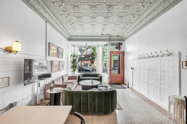 a living room with furniture and a floor to ceiling window